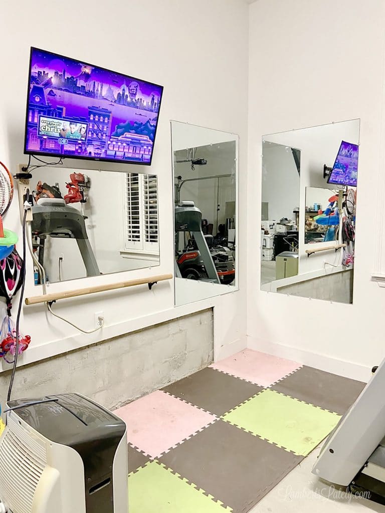 This garage home gym shows how to turn a small space into a functional exercise area. Has a bike, treadmill, strength/weight training area, and TV for Peloton/online workouts.